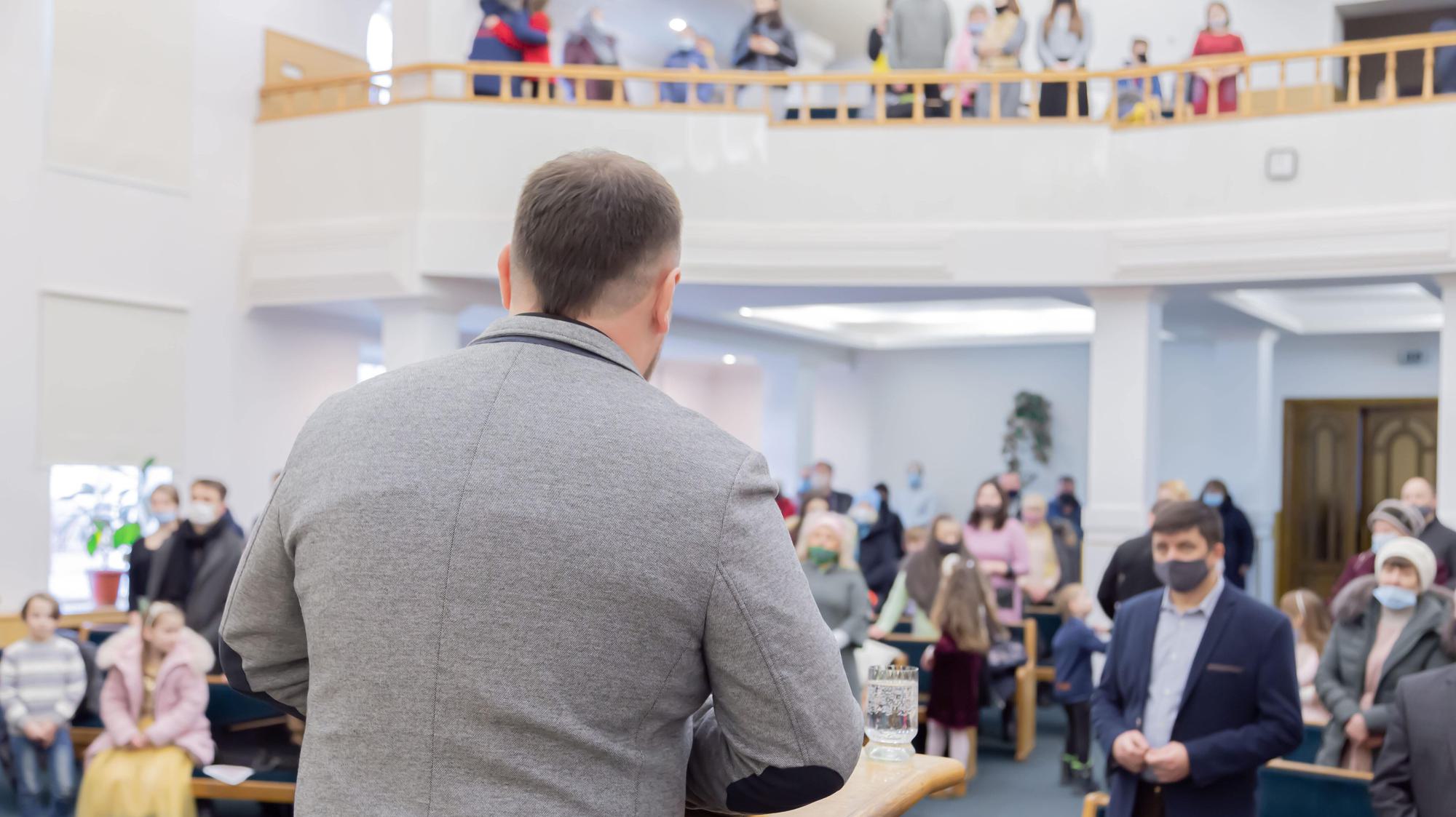 man speaking to church audience