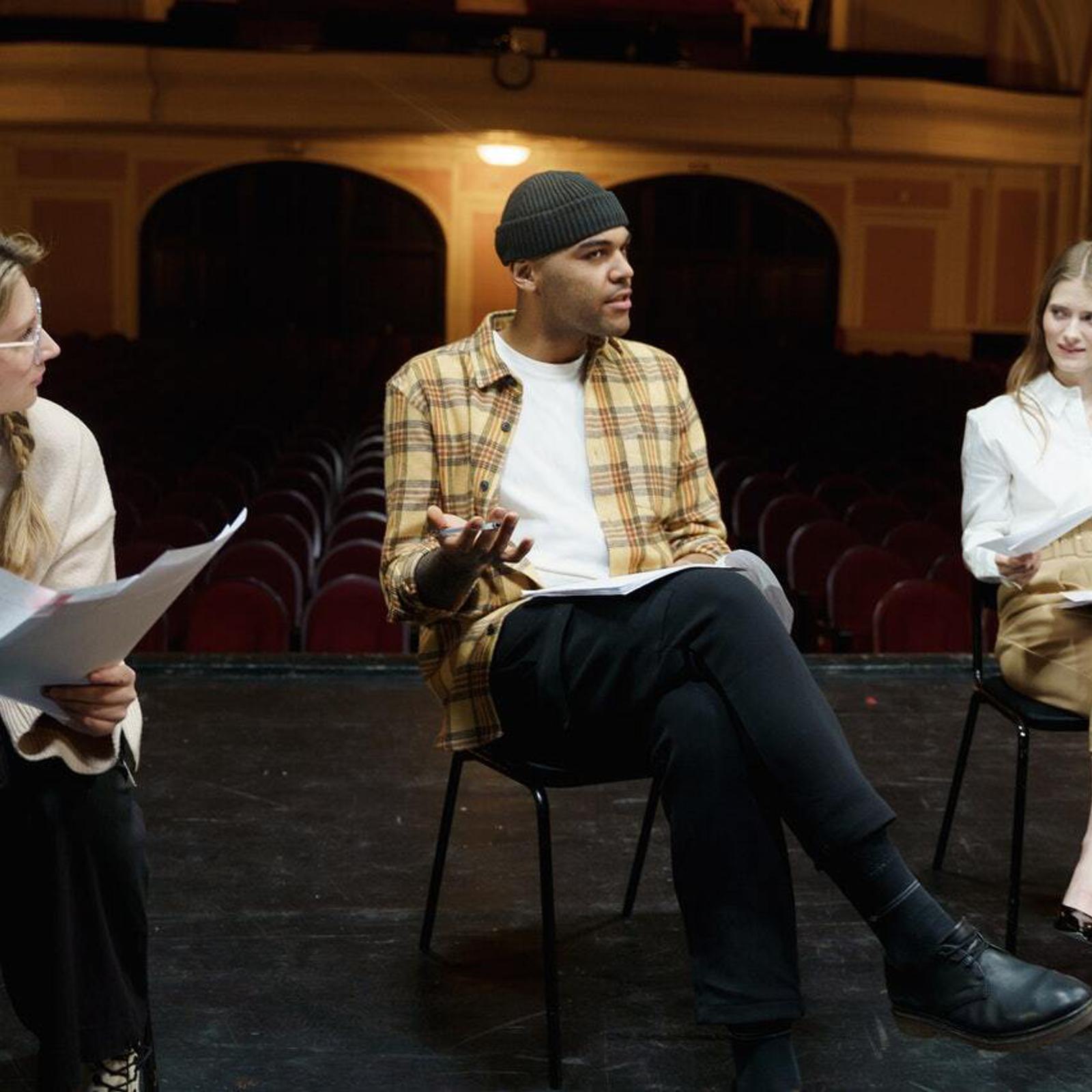 people rehearsing drama on a stage