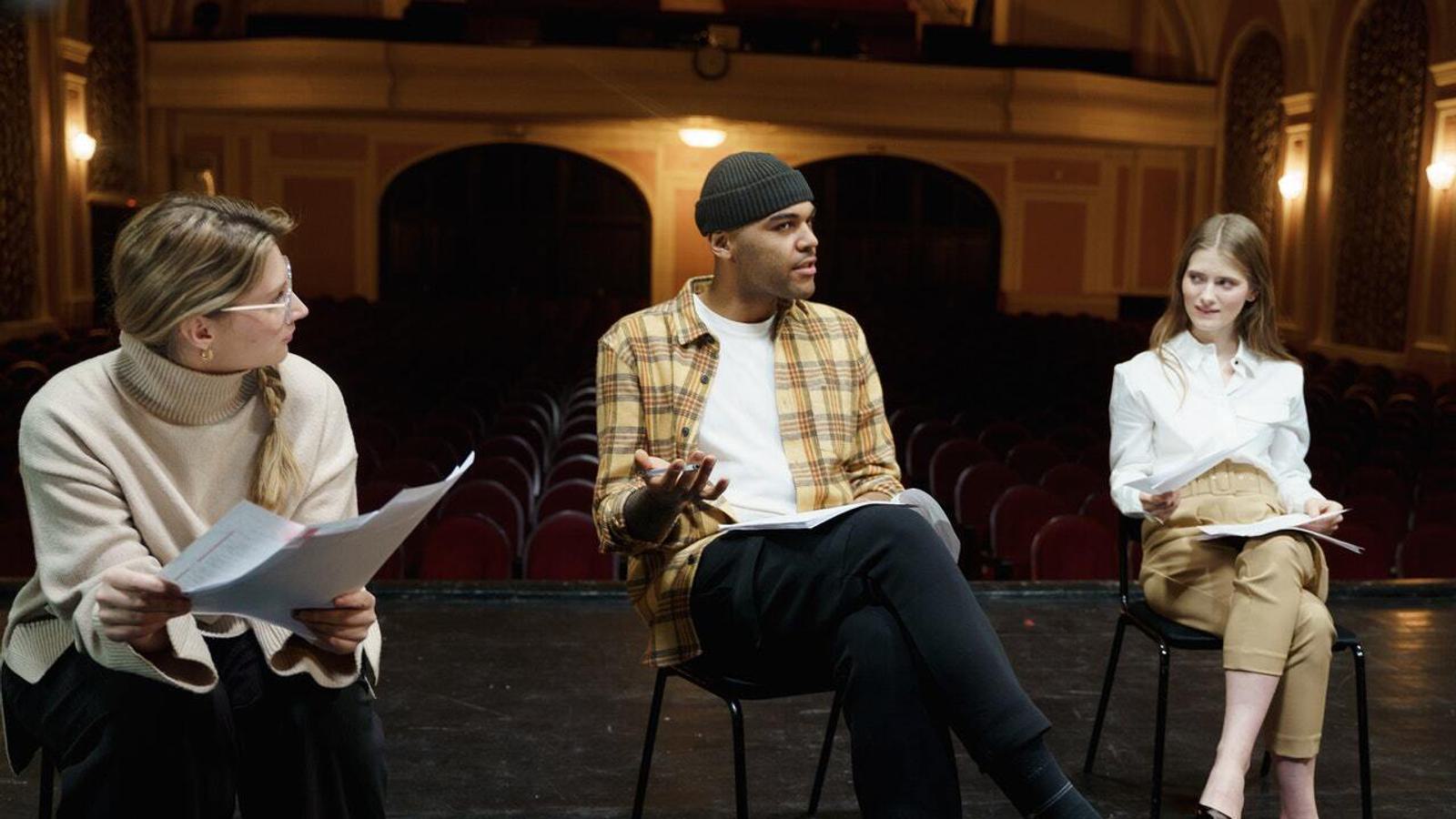people rehearsing drama on a stage