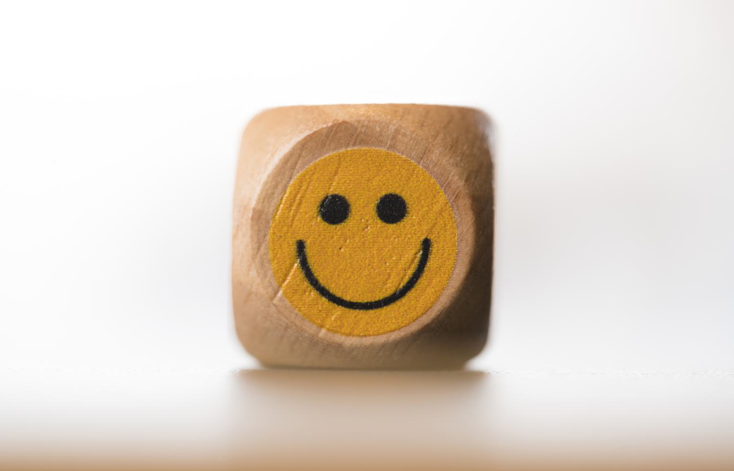 Beautifully crafted wooden dice with a different emoticon on each face